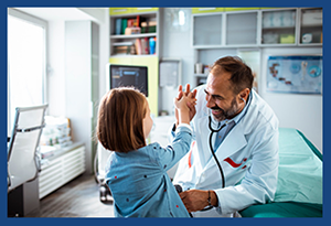 A pediatrician high fives a child patient